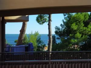 a view of the ocean from a house balcony at Appartamento Mirabell, FRONTE SPIAGGIA, VISTA MARE CON PARCHEGGIO in Grado