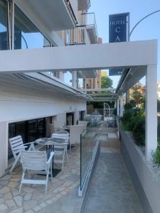 a patio with chairs and a table in a building at Hotel Capri in San Benedetto del Tronto