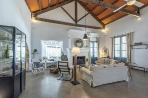 a large living room with couches and chairs in it at Hacienda San Antonio in Marchena