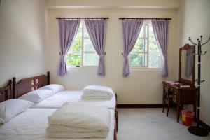 Кровать или кровати в номере Tian Mama Homestay
