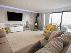 a living room with a couch and a fireplace at The Mount in Prestatyn