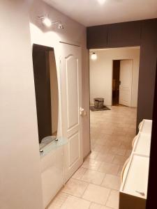 a hallway with a door and a mirror in a room at Smart Stay Apartment in Valmiera +2 photos