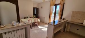 a living room with a kitchen and a dining room at B&B Villa Eleonora Tropea in Le Pioppe