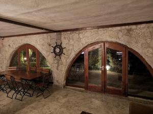 a dining room with a table and a clock on the wall at Marina Park in Vama Veche