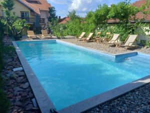 a swimming pool with blue water in a yard at Apartmani ,,Vasa ,, 3 in Soko Banja