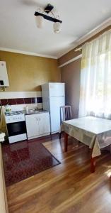 a kitchen with a table in the middle of a room at 19 Одна комнатная квартира в центре in Shymkent