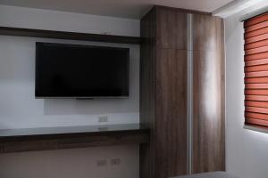 a living room with a flat screen tv on a wall at Sun Vida Tower Studio Unit Across SM City Cebu in Cebu City