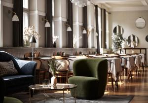 un comedor con mesas y sillas largas en Fiftyseven Hotel Copenhagen, en Copenhague