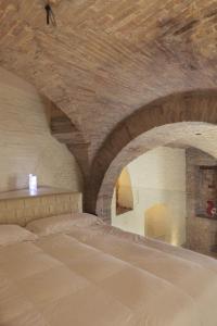 a bedroom with a large bed with a wooden ceiling at DesArt sweet Poeta in Perugia