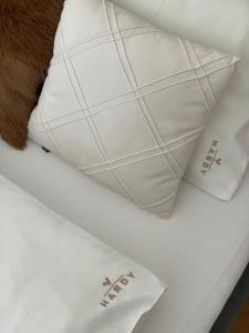 two white pillows sitting on top of a table at HARDY - Cognac & Pension in Valtice