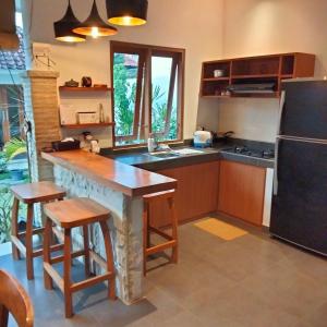 a kitchen with a table and a refrigerator at 3 Orchid in Sanur