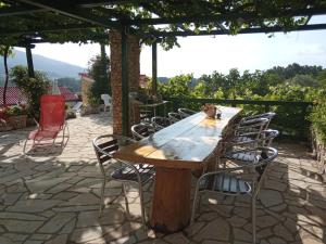 a wooden table and chairs on a patio at KATY&MLADEN in Baška