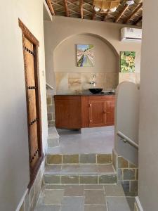 a bathroom with a sink and a stone floor at Nizwa Heritage Inn in Nizwa
