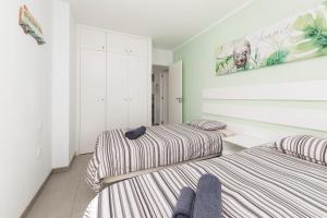 A bed or beds in a room at MEDANO4YOU La Terraza Los Martines