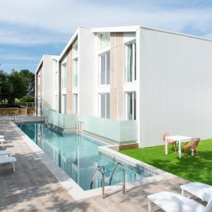 an image of a building with a swimming pool at Píllaras da Lanzada in A Lanzada