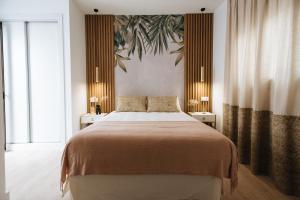 En eller flere senge i et værelse på Magno Apartments Azafrán