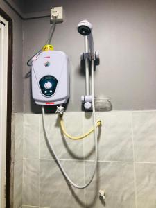 a blow dryer is attached to a wall in a bathroom at Julies Hostel Taman Negara in Kuala Tahan