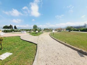 a walkway in a park with a grass field at Villa Regina - Sperlonga Vertice Rooms in Sperlonga