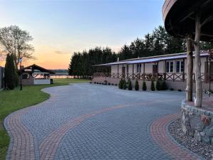 a cobblestone driveway in front of a building at Siedlisko Miluki - Apartamenty nad Jeziorem z Jacuzzi & Sauną in Ełk