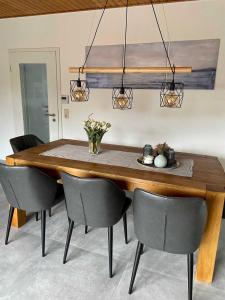 a dining room table with chairs and a dining room at Ferienhaus Meeresleuchten, frisch renoviertes & gemütliches in Hooksiel