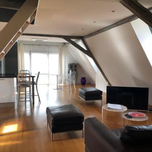 a living room with a couch and a table at DUPLEX 15 in Colmar