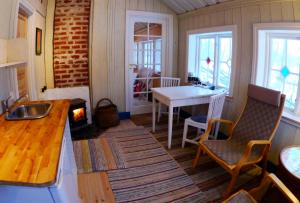 a kitchen with a table and a stove in a room at Tystberga Logi in Tystberga