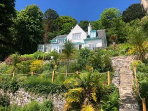 a house on a hill with trees and plants at Afallon in Menai Bridge