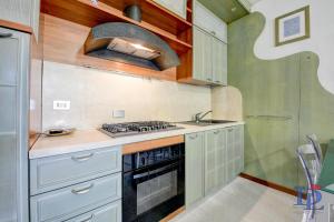 A kitchen or kitchenette at Desenzanoloft Official Partner MARRIOTT Homes & Villas - Dolce vita with Garden and Pools