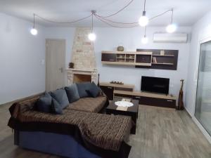 a living room with a couch and a table at Christen house in Periyiálion