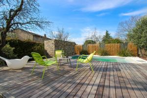 a patio with chairs and a table and a pool at La Villa des Temps Modernes in Albi