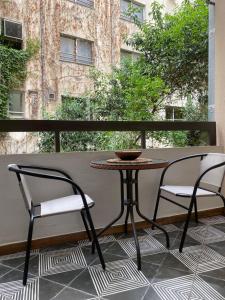 a small table and two chairs on a balcony at Dreamy Central Corner in Thessaloniki