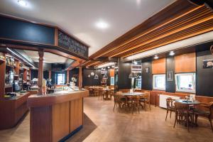 a restaurant with tables and chairs and a bar at Hotel Prebold in Prebold