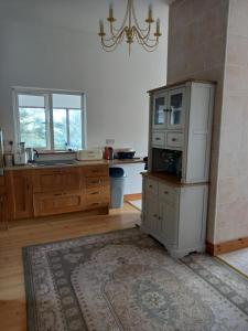 a kitchen with a refrigerator and a sink in it at Two bed bungalow with sunroom and stunning views in Killybegs