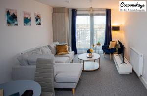 a living room with a couch and a table at Cocooonstays Stays Short Lets & Serviced Accommodation Slough in Slough