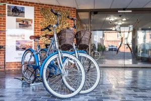 two bikes are parked in front of a store at The Maids Head Hotel in Norwich