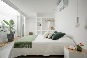 Ένα ή περισσότερα κρεβάτια σε δωμάτιο στο Casa Nova