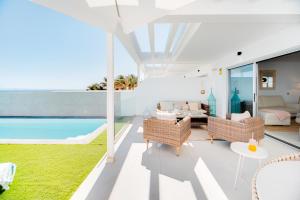 a living room with a view of a pool at Mara Marina Suites 4 in Playa Blanca