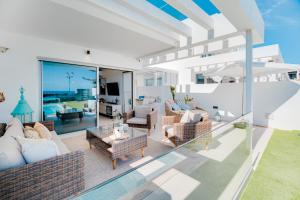 a living room with a view of the ocean at Mara Marina Suites 4 in Playa Blanca