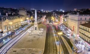 a city at night with a monument in the middle at Altis Avenida Hotel in Lisbon