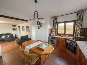 a kitchen and living room with a table and a dining room at Casa Las Huertas in La Vegueta