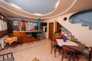 a kitchen with a staircase and a dining room with tables at Golden Sun in Agios Ioannis Pelio +62 photos
