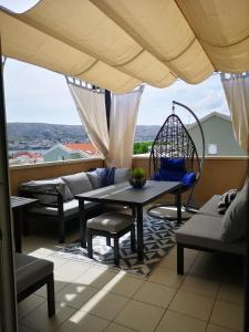 a balcony with a table and chairs and a view at Apartment Marta in Pag