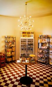 a store with a checkered floor and a chandelier at Le Petit Château in Baye