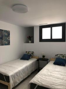 a bedroom with two beds and a window at Villa Isla Plana, right by the sea - Grande in Isla Plana