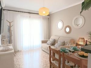 a living room with a couch and a table at Hotel Nou Can Guillem in Cala Figuera