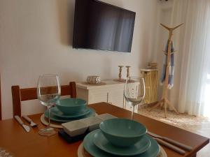 a dining room table with two plates and wine glasses at Hotel Nou Can Guillem in Cala Figuera