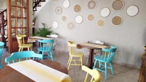 a restaurant with tables and chairs and mirrors on the wall at Hotel Nou Can Guillem in Cala Figuera