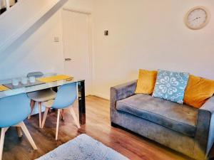 a living room with a couch and a table at Primrose House in Whitefield