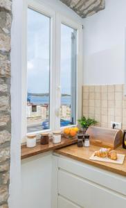 a kitchen with a counter with a window at Apartment Augusto - Sea view in Pula