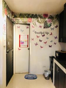 a kitchen with a door with butterflies on the wall at Downtown Prominenza 844 in Baliuag
